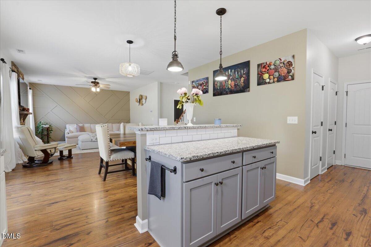 136 Fallingbrook Drive Kenly, NC 27542 - Photo 20 of 54 a kitchen with granite countertop a stove a sink and a wooden floor