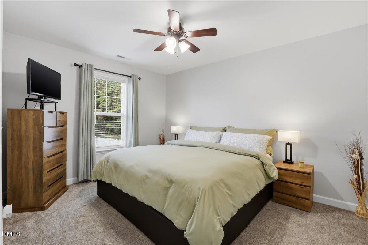 136 Fallingbrook Drive Kenly, NC 27542 - Photo 27 of 54 a bedroom with a bed and a flat screen tv