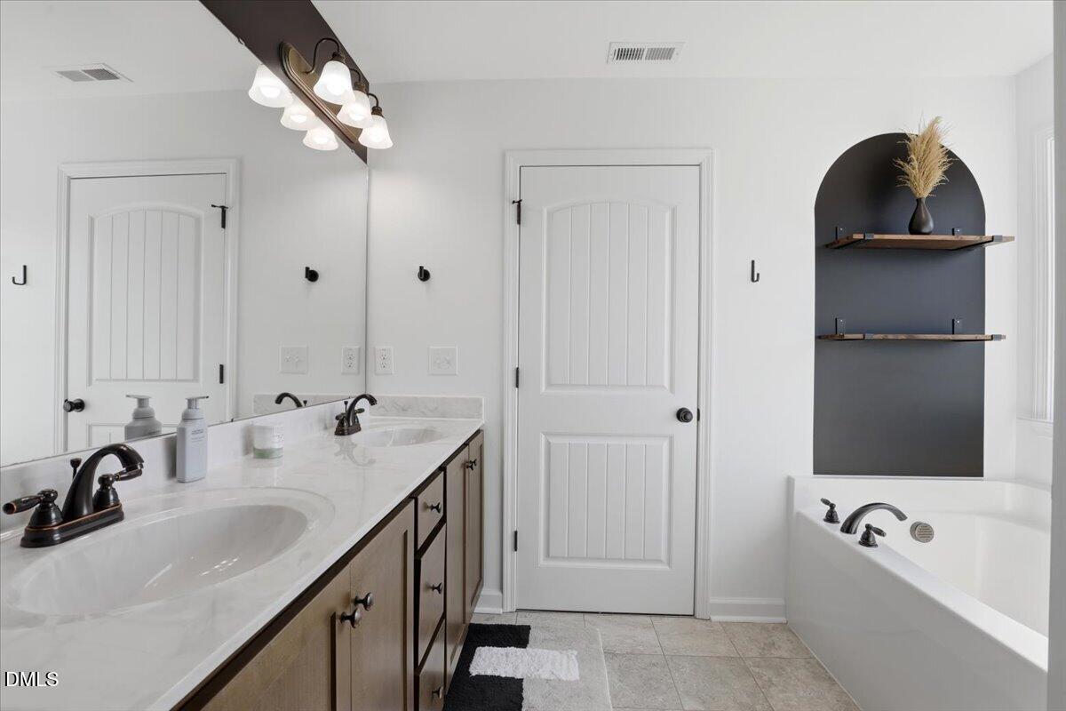 136 Fallingbrook Drive Kenly, NC 27542 - Photo 32 of 54 a bathroom with a sink and mirror