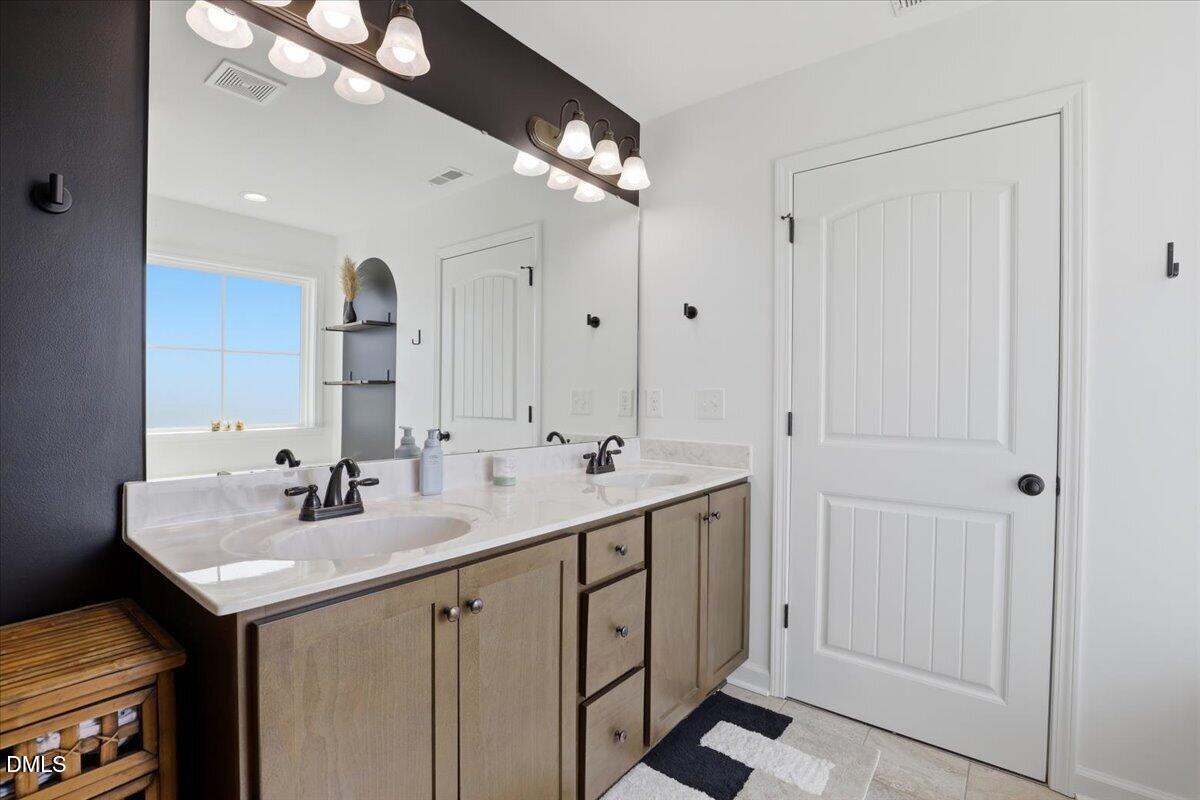 136 Fallingbrook Drive Kenly, NC 27542 - Photo 33 of 54 a bathroom with double sink and a mirror
