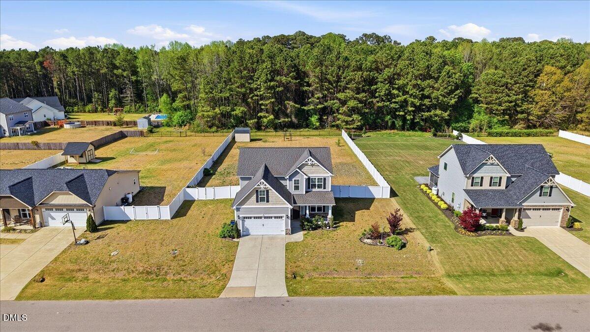 136 Fallingbrook Drive Kenly, NC 27542 - Photo 45 of 54 a view of swimming pool with outdoor seating and trees in the background