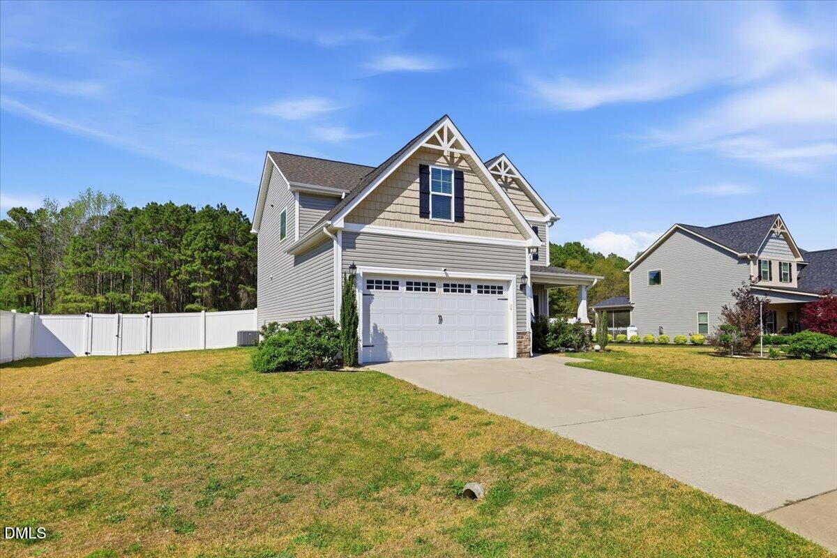 136 Fallingbrook Drive Kenly, NC 27542 - Photo 3 of 54 a front view of a house with a yard and garage