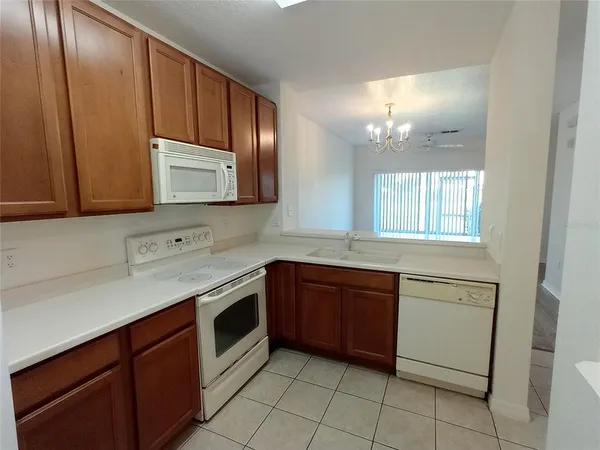 a kitchen with stainless steel appliances granite countertop a sink stove and microwave