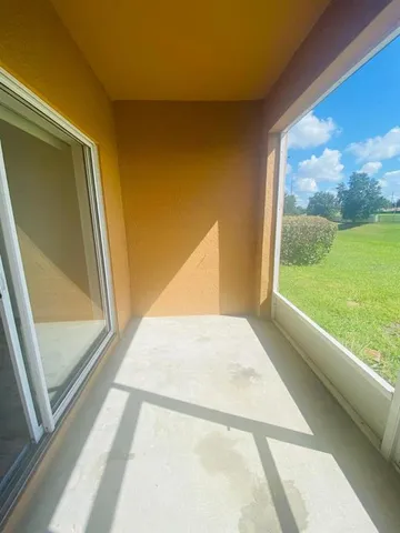 a view of an empty room and a window