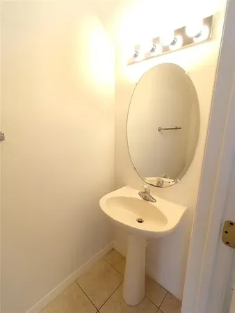 a bathroom with a sink mirror and toilet