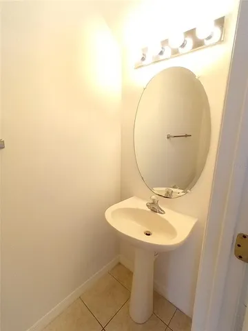 a bathroom with a sink mirror and toilet