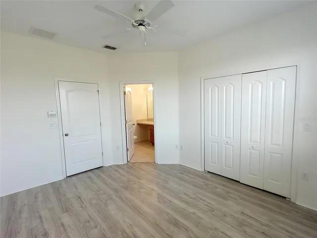 an empty room with closet and a bathroom