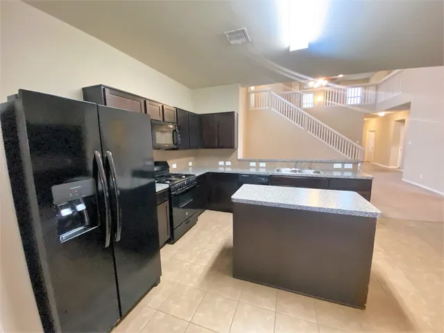 a kitchen with a refrigerator and a sink