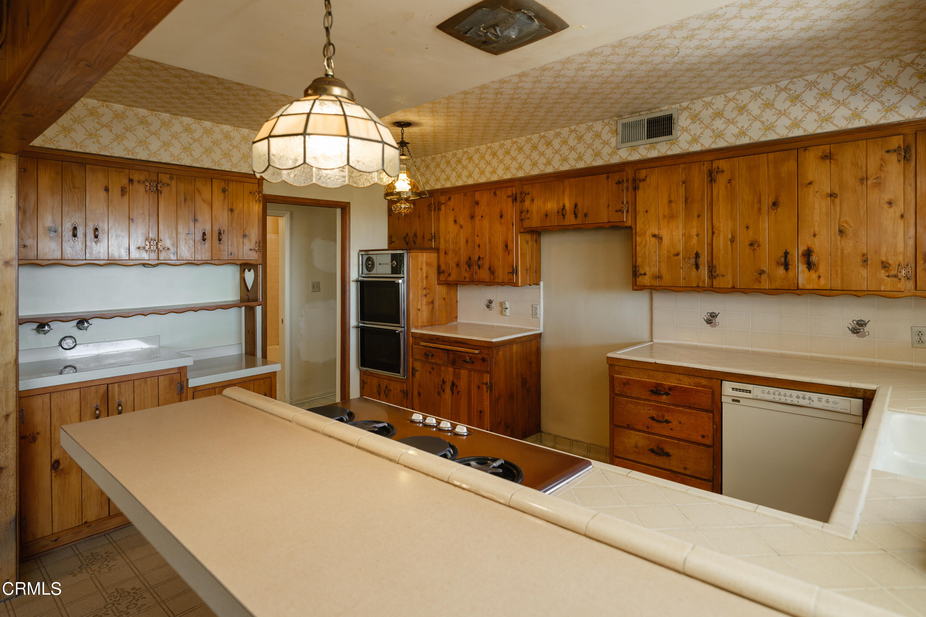 7162 Estepa Drive Tujunga, CA 91042 - Photo 17 of 43 a kitchen with refrigerator cabinets and a stove