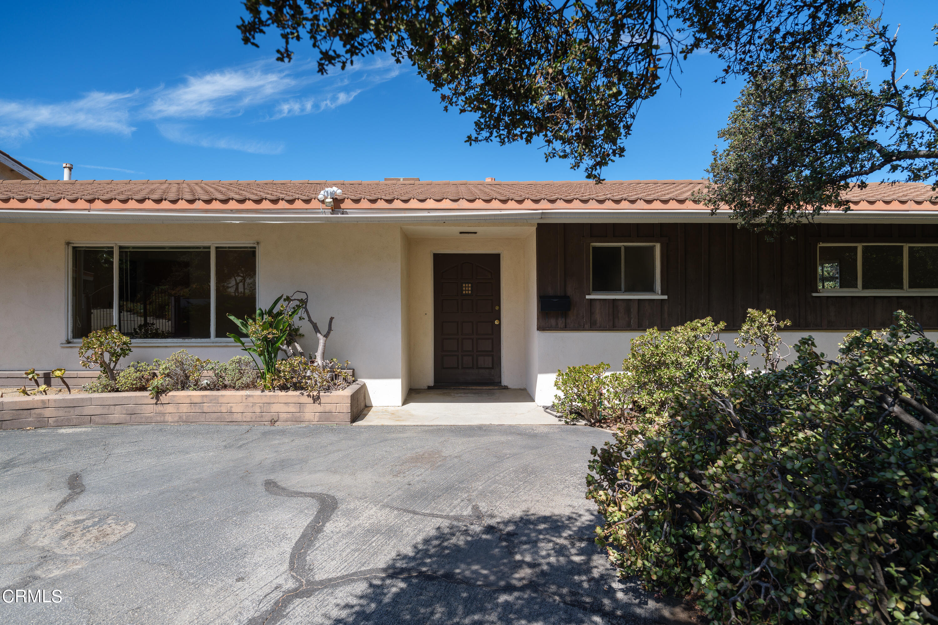 7162 Estepa Drive Tujunga, CA 91042 - Photo 7 of 43 a view of a house with potted plants and a large tree