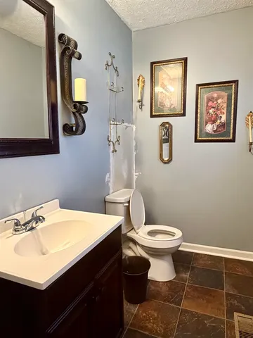 a bathroom with a sink mirror and toilet