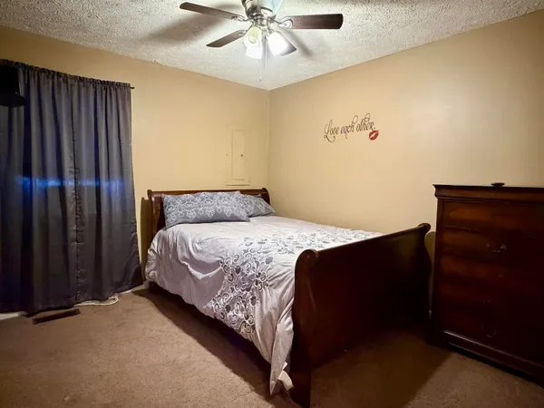 a bed sitting in a bedroom next to a cabinet