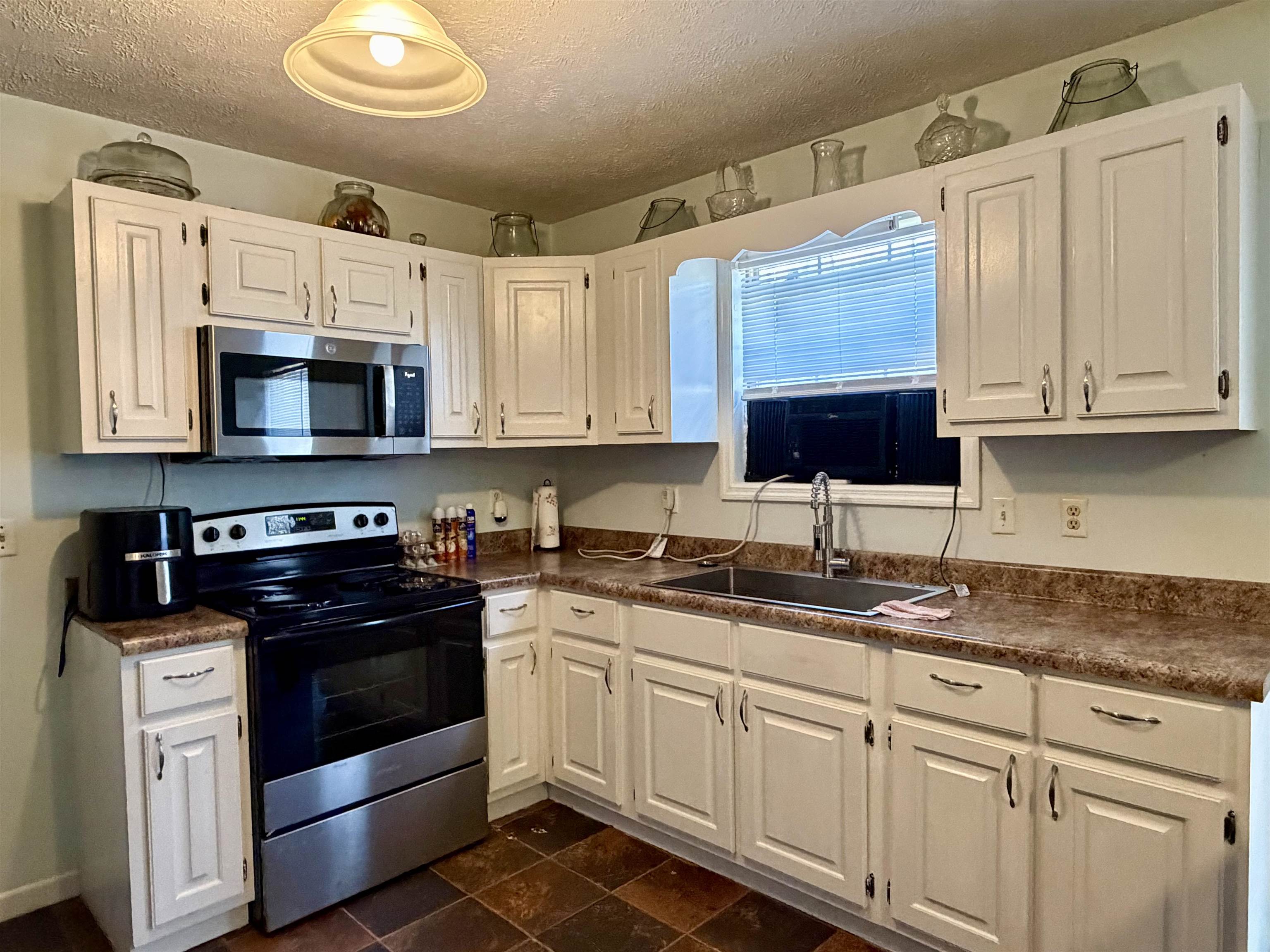 82 Shane Lane Ramer, TN 38367 - Photo 7 of 18 a kitchen with granite countertop white cabinets white stainless steel appliances and a sink