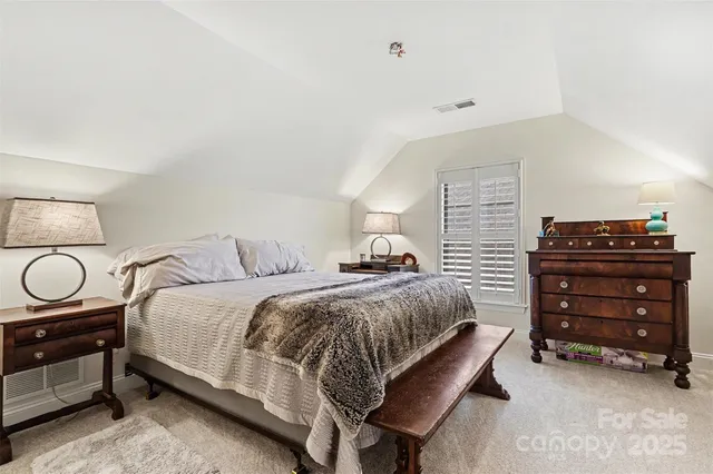 a bedroom with a bed and cabinets