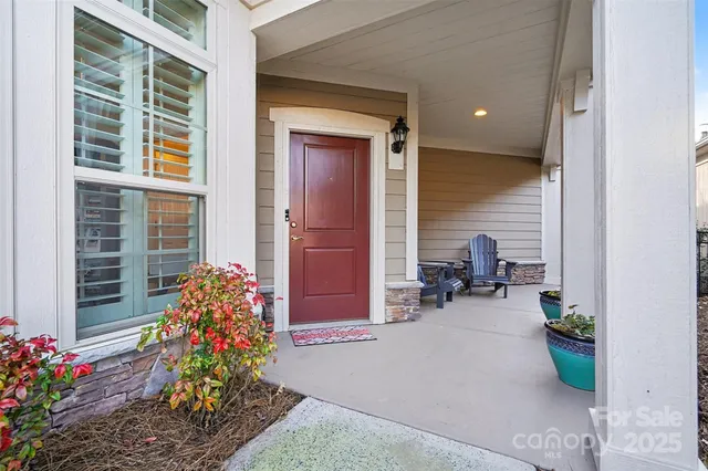 a lobby with furniture and flowers