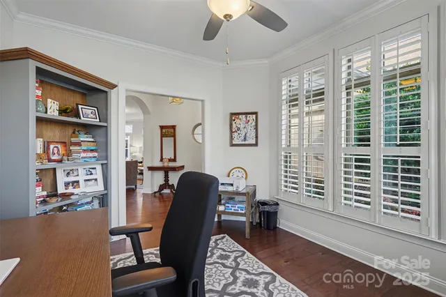 a view of a livingroom with workspace and a window