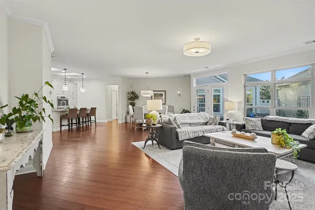 a living room with fireplace furniture and a wooden floor