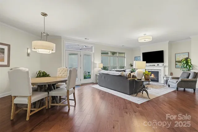 a living room with furniture flat screen tv and wooden floor