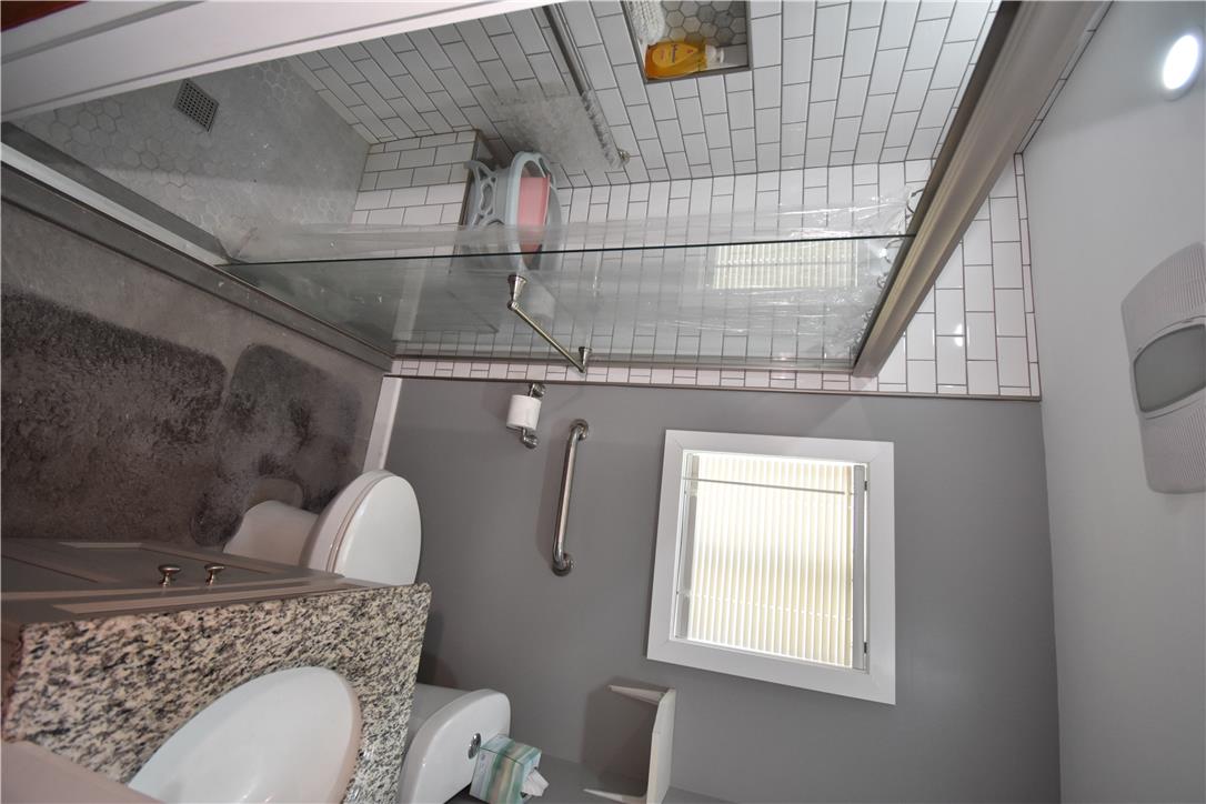 1440 Butler Street Easton, PA 18042 - Photo 7 of 23 Granite counters complement the accessible shower and clean-lined vanity.