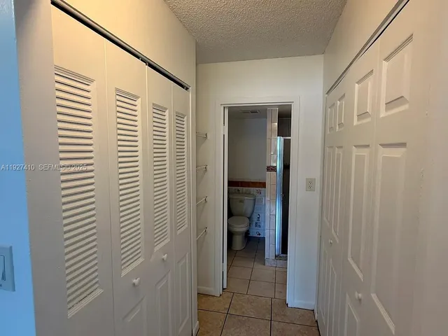 a view of a hallway with a bathroom
