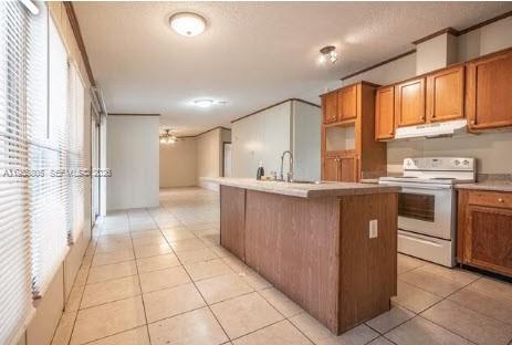 1604 Pineford Road Lakeland, FL 33809 - Photo 11 of 28 a kitchen with stainless steel appliances granite countertop a stove a sink and a refrigerator