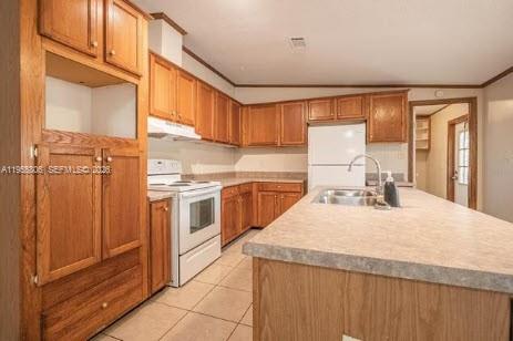 1604 Pineford Road Lakeland, FL 33809 - Photo 12 of 28 a kitchen with a stove a sink and a refrigerator