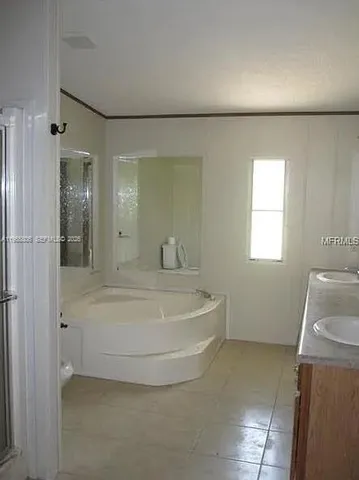 a spacious bathroom with a bathtub and shower