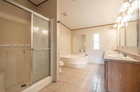 1604 Pineford Road Lakeland, FL 33809 - Photo 22 of 28 a bathroom with a double vanity sink toilet and shower