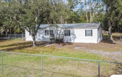 1604 Pineford Road Lakeland, FL 33809 - Photo 28 of 28 a view of a white house with a outdoor space