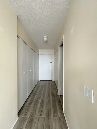 a view of a hallway with wooden floor