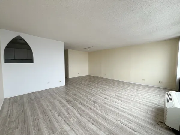 a view of an empty room and wooden floor