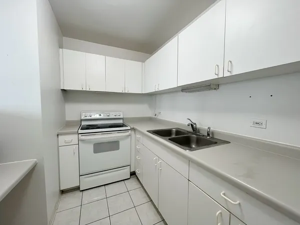 a kitchen with white cabinets and white appliances