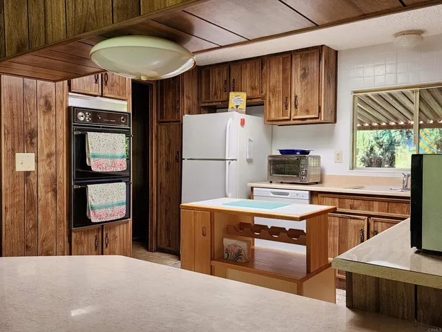 a kitchen with a sink and a stove next to a window