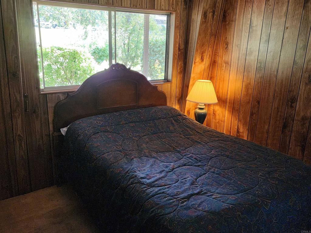 18218 Paradise Mountain Road Valley Center, CA 92082 - Photo 21 of 32 a bed sitting in a bedroom next to a window