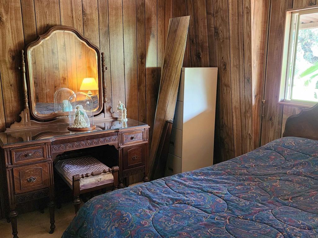18218 Paradise Mountain Road Valley Center, CA 92082 - Photo 22 of 32 a bedroom with a bed and a mirror