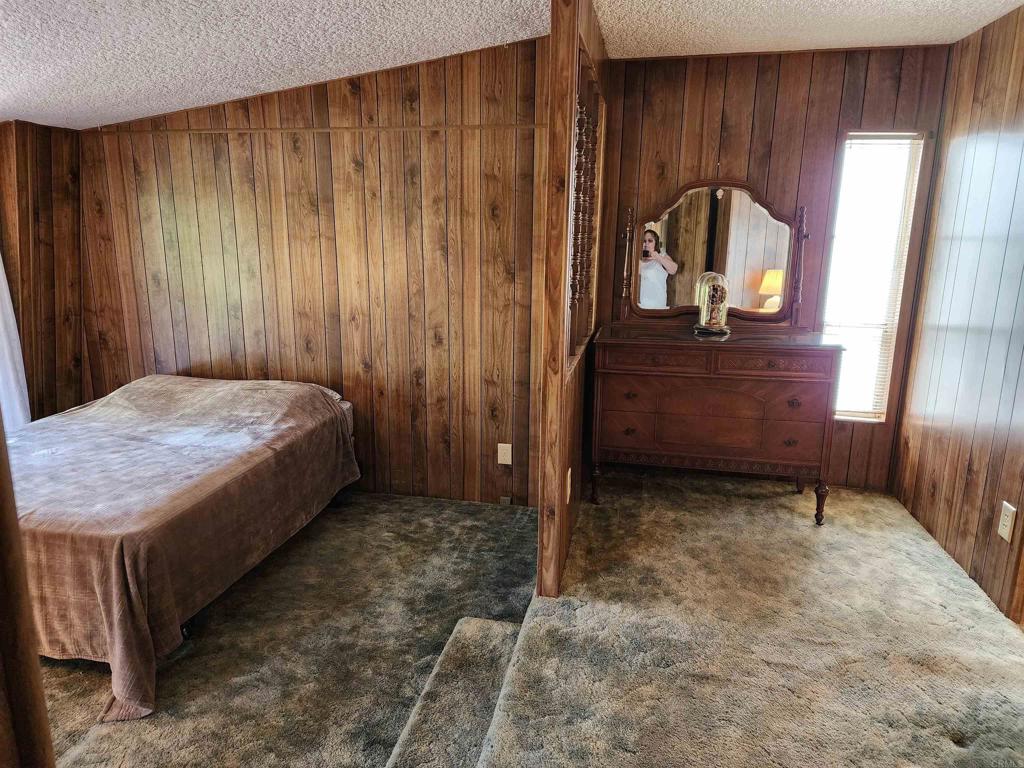 18218 Paradise Mountain Road Valley Center, CA 92082 - Photo 24 of 32 a bed sitting in a room next to a window