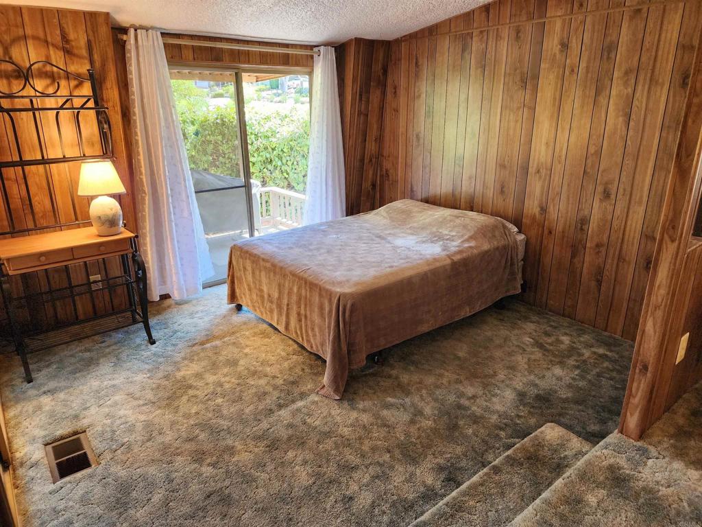 18218 Paradise Mountain Road Valley Center, CA 92082 - Photo 26 of 32 a bed sitting in a room next to a window