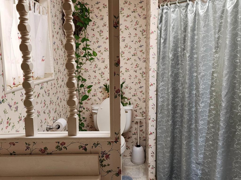 18218 Paradise Mountain Road Valley Center, CA 92082 - Photo 28 of 32 a bathroom with a bathtub and shower curtain