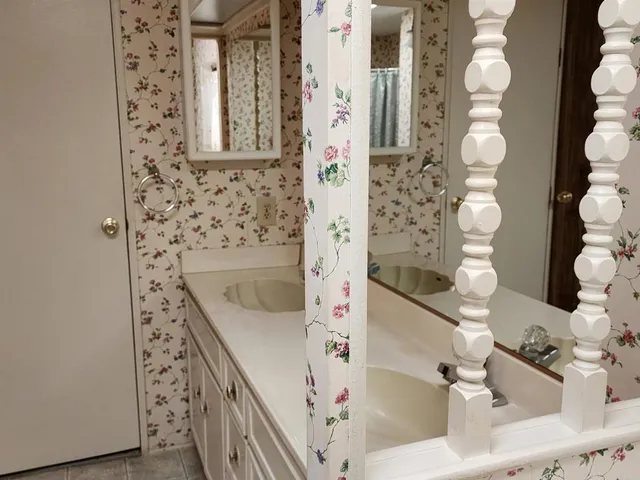 a view of a hallway with paintings on the wall