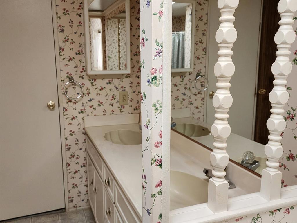 18218 Paradise Mountain Road Valley Center, CA 92082 - Photo 29 of 32 a bathroom with a sink and a mirror