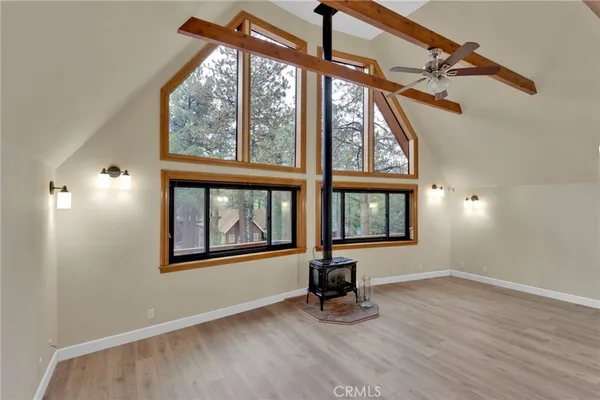 a view of a chandelier fan and wooden floor