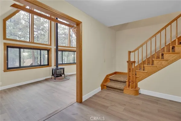 a view of an entryway with wooden floor and door