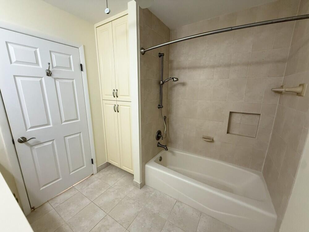 114 Beach Summit Court Jupiter, FL 33477 - Photo 31 of 32 a bathroom with a bathtub and a shower