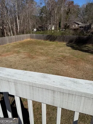 a view of a swimming pool with a yard