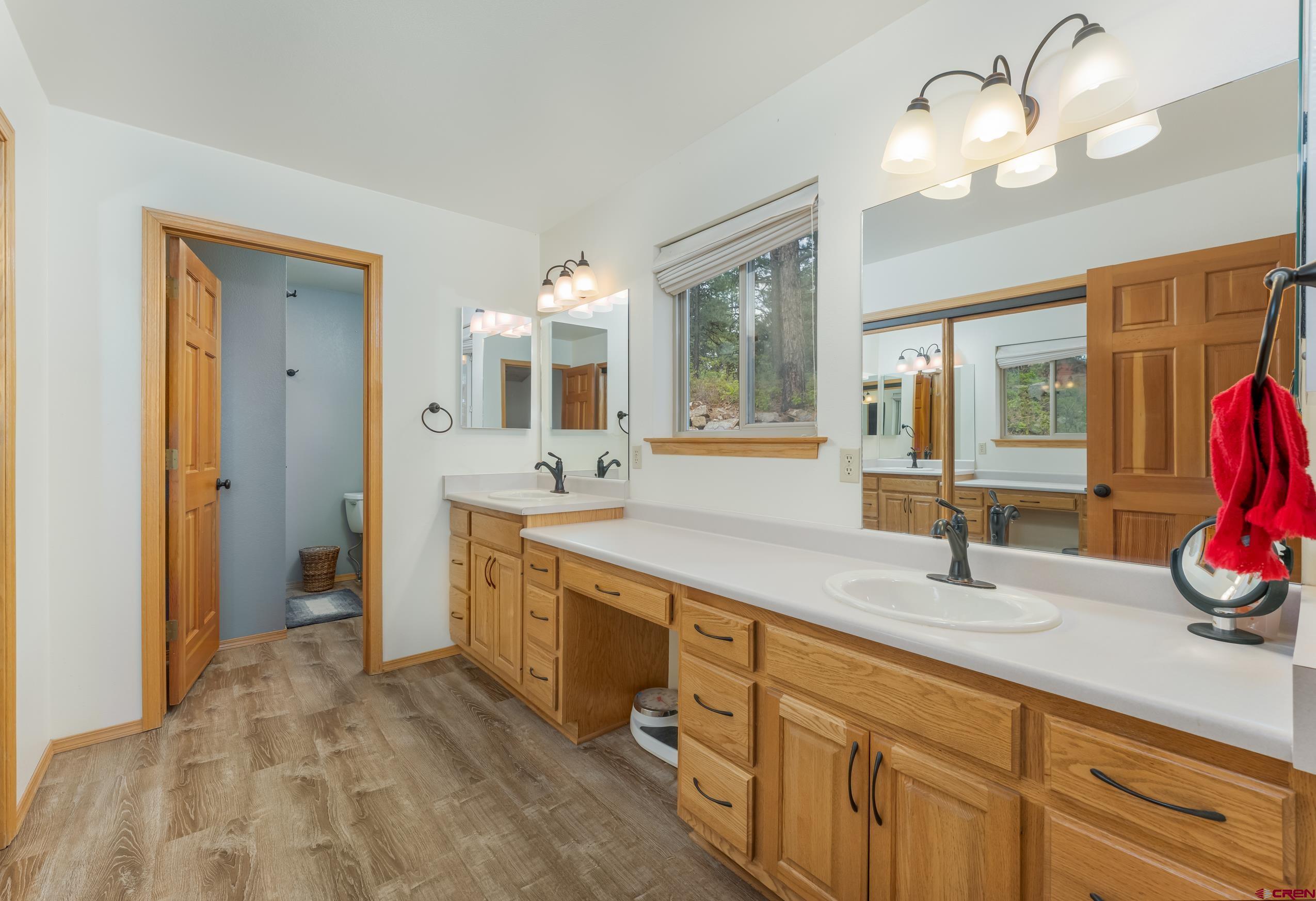197 Buckhorn Road Bayfield, CO 81122 - Photo 18 of 34 a spacious bathroom with double vanity a mirror and a shower
