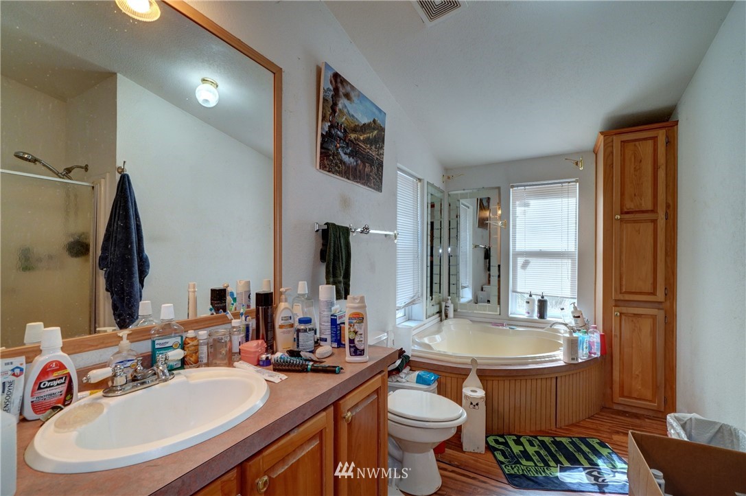 16543 Williams Lane Southwest Rochester, WA 98579 - Photo 14 of 34 a bathroom with a sink double vanity granite and a mirror