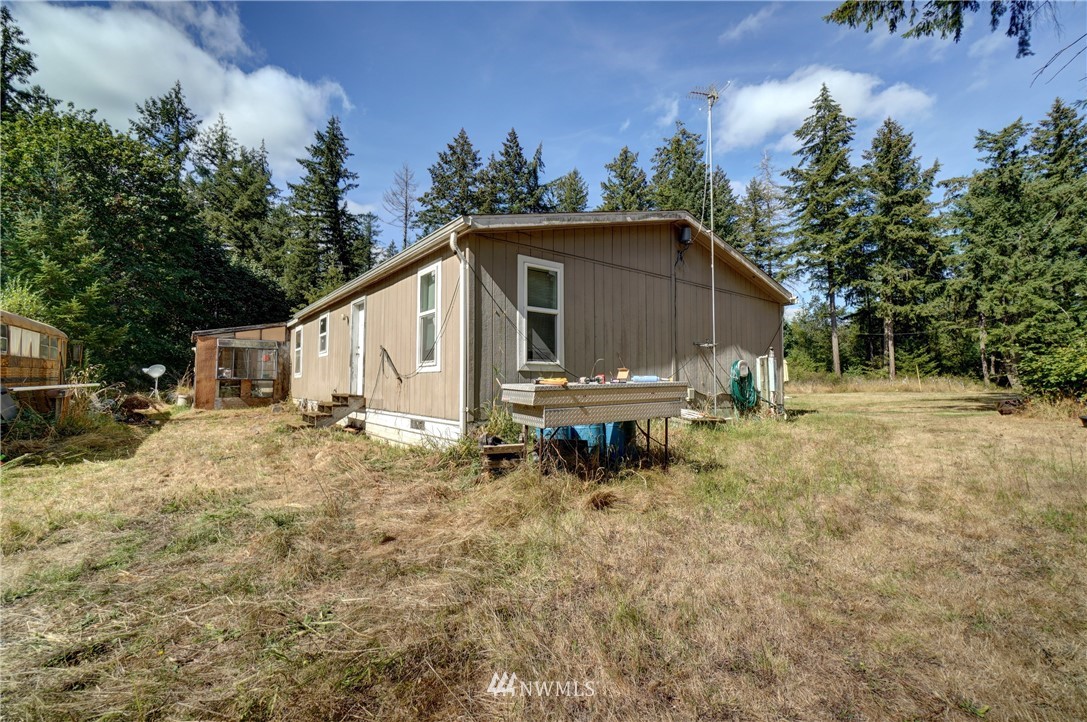 16543 Williams Lane Southwest Rochester, WA 98579 - Photo 22 of 34 a backyard of a house with table and chairs