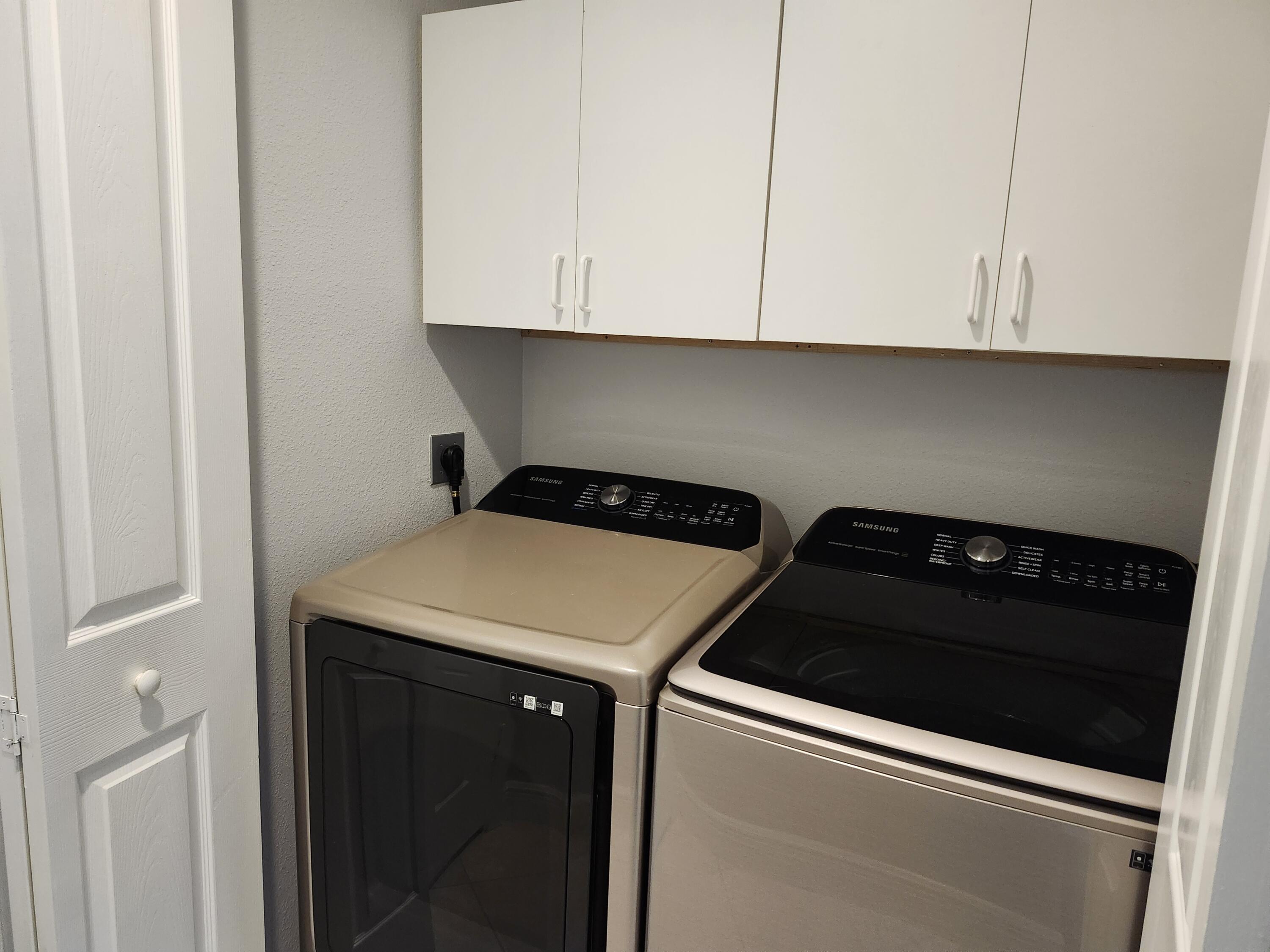 108 Morning Dew Circle Jupiter, FL 33458 - Photo 12 of 46 a kitchen with a stove and white cabinets