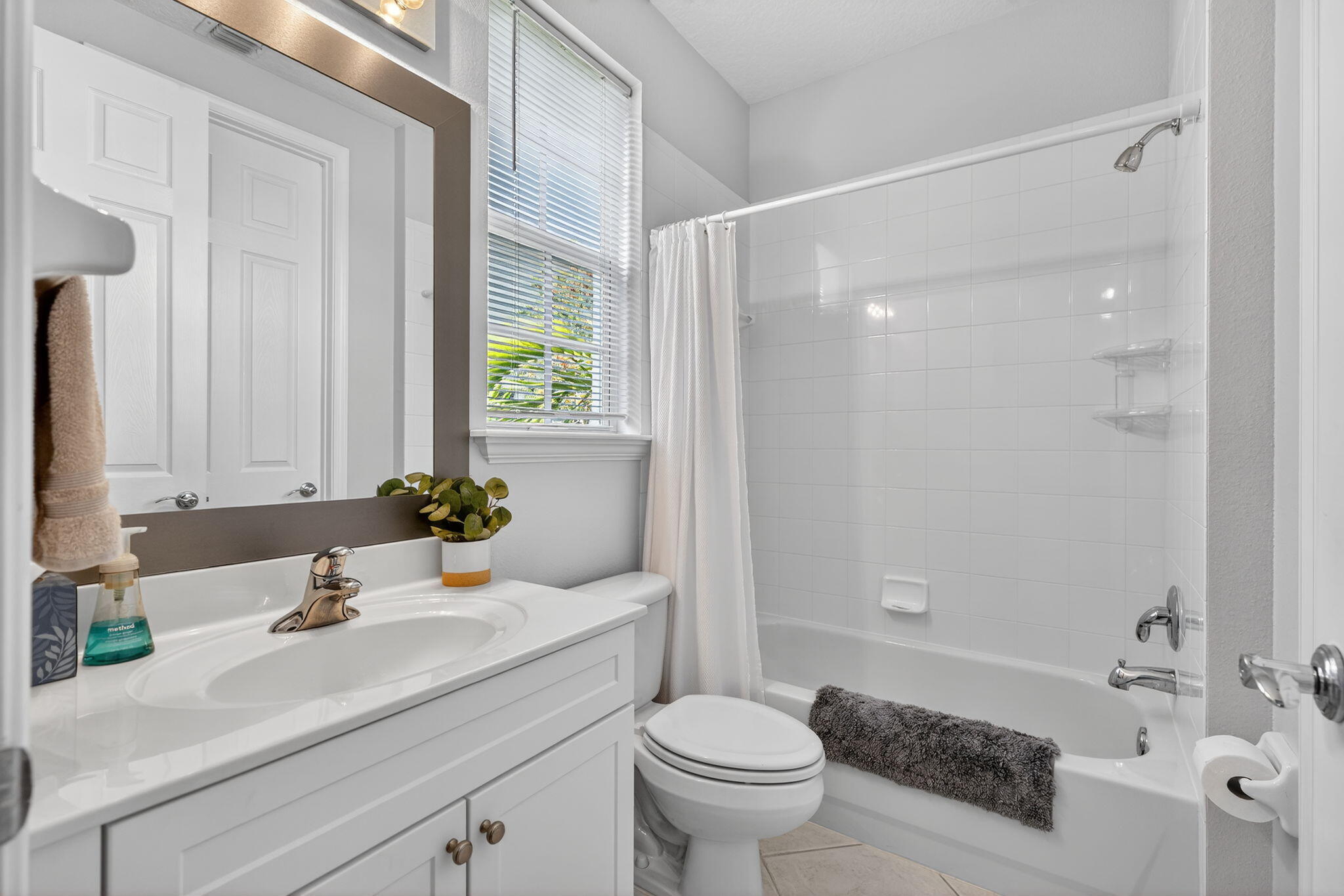 108 Morning Dew Circle Jupiter, FL 33458 - Photo 17 of 46 a bathroom with a sink and a mirror