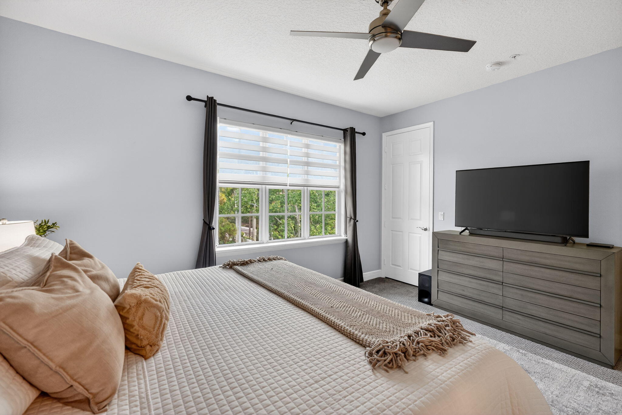 108 Morning Dew Circle Jupiter, FL 33458 - Photo 23 of 46 a bedroom with a bed and a flat screen tv